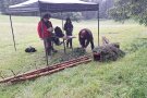 Mehrere Personen unter Pavillon auf einer Wiese